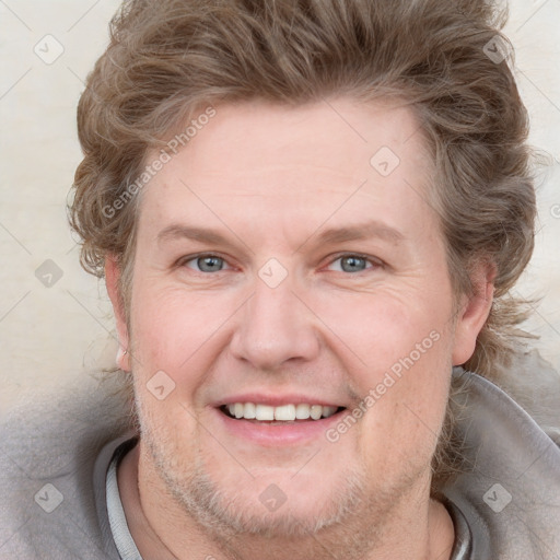 Joyful white adult male with short  brown hair and grey eyes