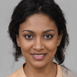 Joyful black young-adult female with medium  brown hair and brown eyes