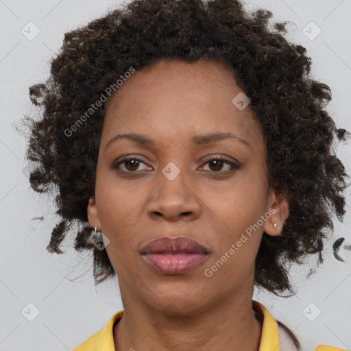 Joyful black adult female with medium  brown hair and brown eyes