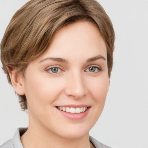 Joyful white young-adult female with medium  brown hair and grey eyes