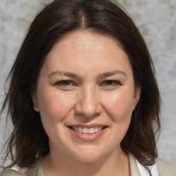 Joyful white adult female with medium  brown hair and brown eyes