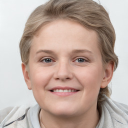 Joyful white young-adult female with medium  brown hair and blue eyes