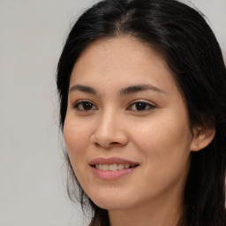 Joyful asian young-adult female with long  brown hair and brown eyes