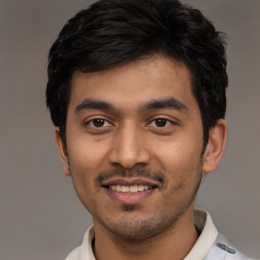 Joyful latino young-adult male with short  black hair and brown eyes