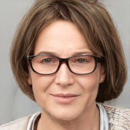 Joyful white adult female with medium  brown hair and grey eyes