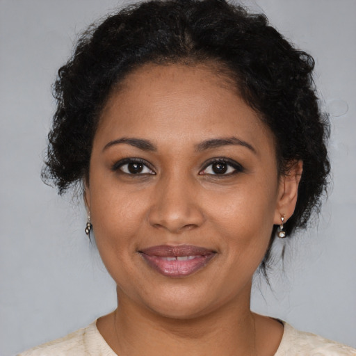 Joyful black young-adult female with medium  brown hair and brown eyes