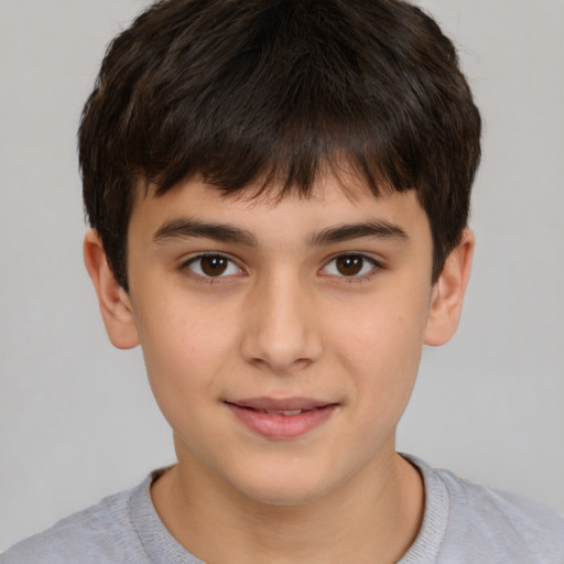 Joyful white child male with short  brown hair and brown eyes