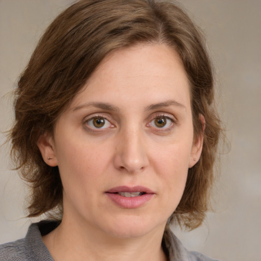 Joyful white young-adult female with medium  brown hair and blue eyes