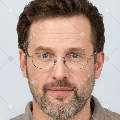 Joyful white adult male with short  brown hair and grey eyes