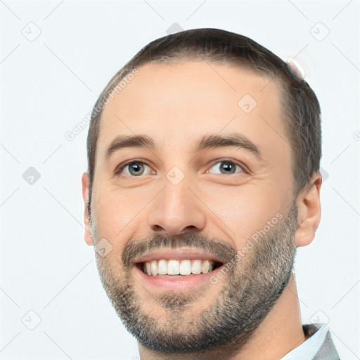 Joyful white young-adult male with short  black hair and brown eyes