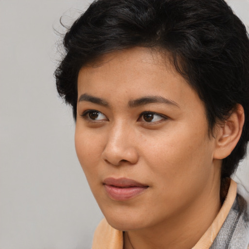 Joyful latino young-adult female with short  brown hair and brown eyes