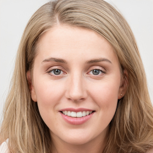 Joyful white young-adult female with long  brown hair and blue eyes