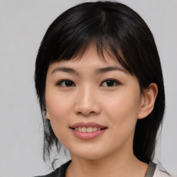 Joyful asian young-adult female with medium  black hair and brown eyes