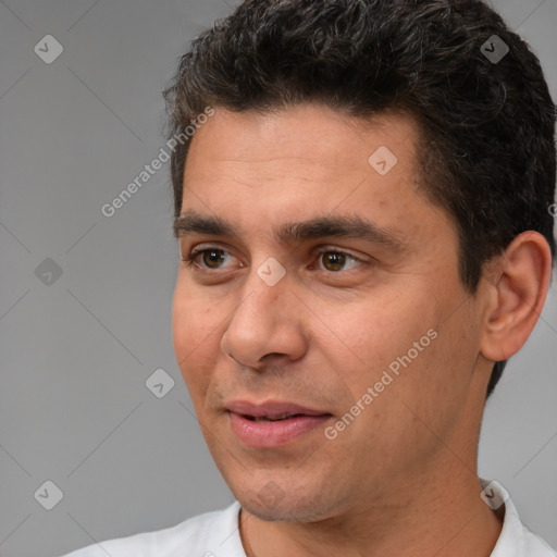 Joyful white young-adult male with short  black hair and brown eyes