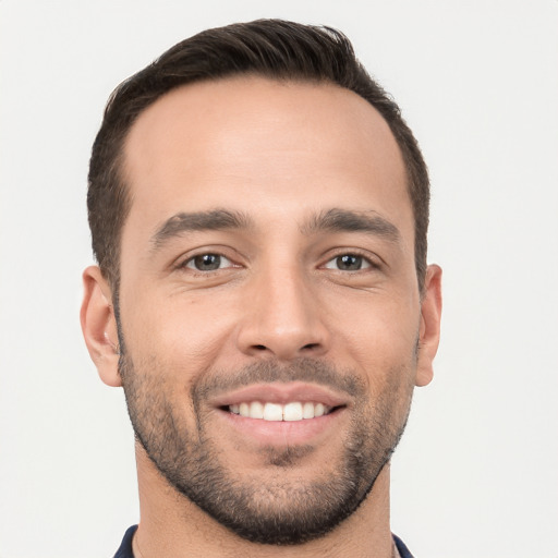 Joyful white young-adult male with short  brown hair and brown eyes