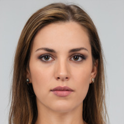 Neutral white young-adult female with long  brown hair and brown eyes