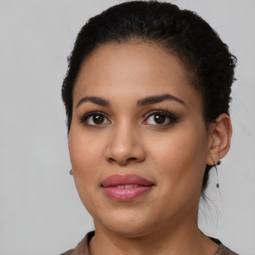 Joyful latino young-adult female with short  brown hair and brown eyes