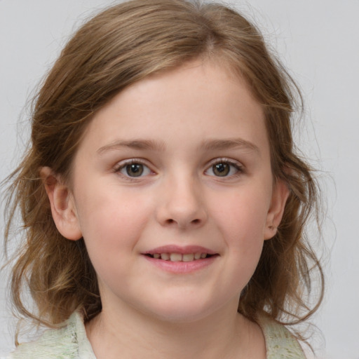 Joyful white child female with medium  brown hair and grey eyes