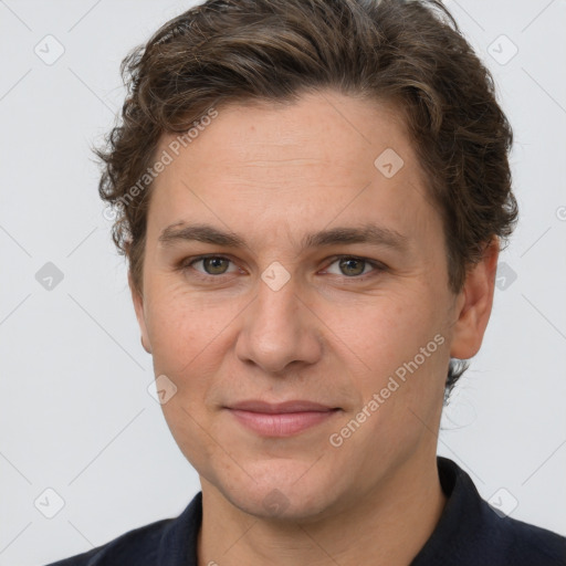 Joyful white adult male with short  brown hair and grey eyes