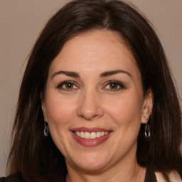 Joyful white adult female with long  brown hair and brown eyes