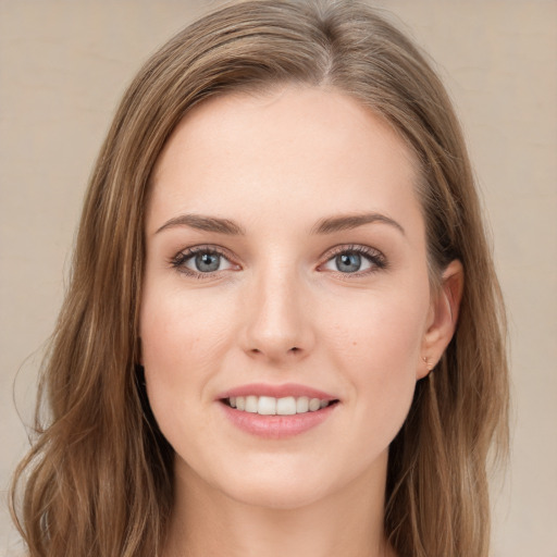 Joyful white young-adult female with long  brown hair and green eyes