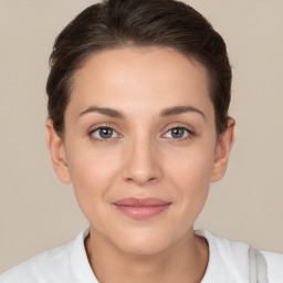 Joyful white young-adult female with short  brown hair and brown eyes