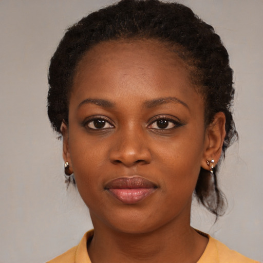 Joyful black young-adult female with medium  brown hair and brown eyes