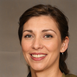 Joyful white adult female with medium  brown hair and brown eyes