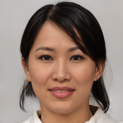 Joyful asian young-adult female with medium  brown hair and brown eyes