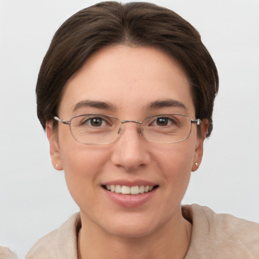 Joyful white young-adult female with short  brown hair and grey eyes