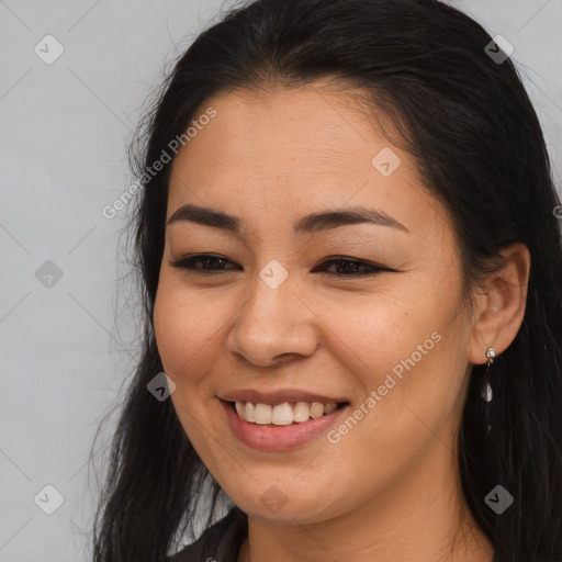 Joyful latino young-adult female with long  brown hair and brown eyes