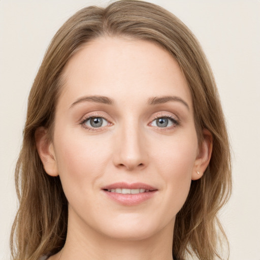 Joyful white young-adult female with long  brown hair and blue eyes