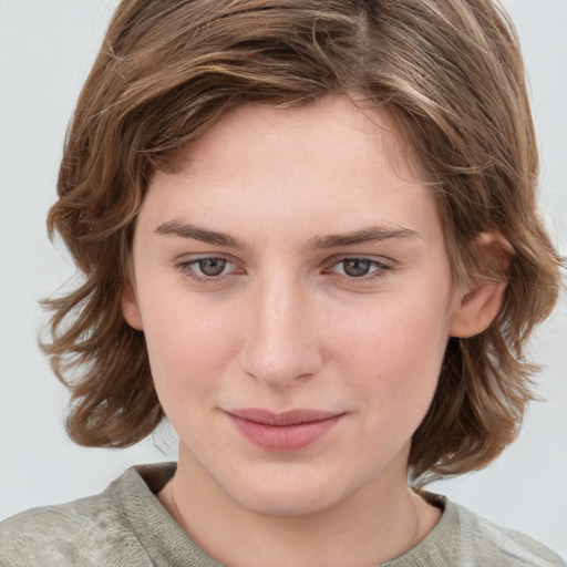 Joyful white young-adult female with medium  brown hair and blue eyes