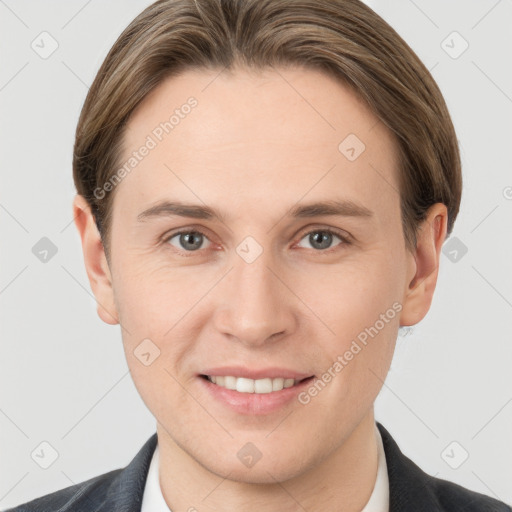 Joyful white young-adult male with short  brown hair and grey eyes