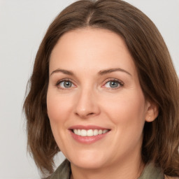 Joyful white young-adult female with medium  brown hair and green eyes