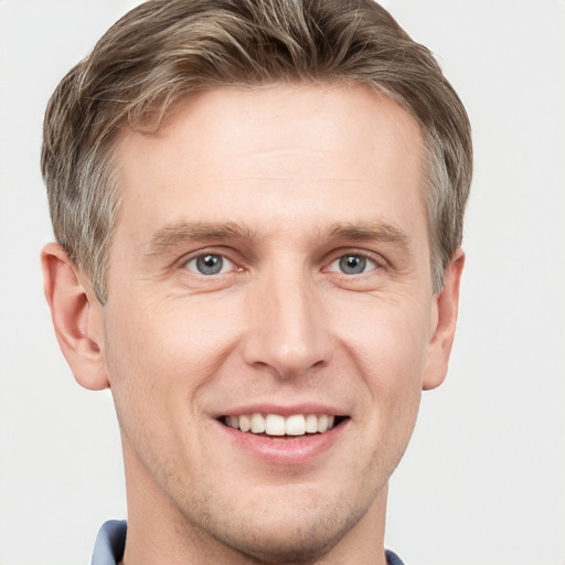 Joyful white adult male with short  brown hair and grey eyes