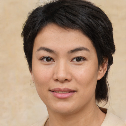 Joyful asian young-adult female with medium  brown hair and brown eyes