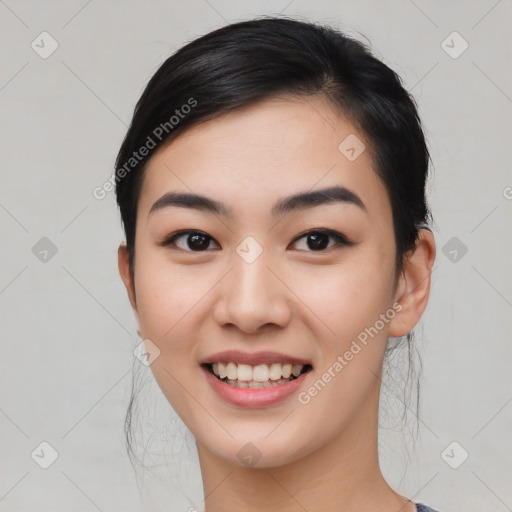 Joyful asian young-adult female with medium  black hair and brown eyes