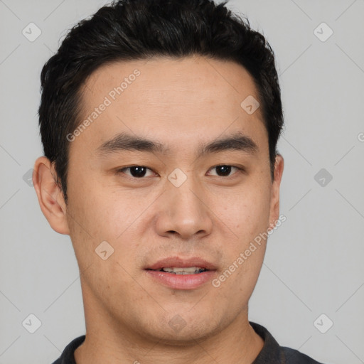 Joyful asian young-adult male with short  black hair and brown eyes