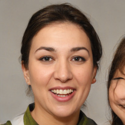 Joyful white adult female with medium  brown hair and brown eyes