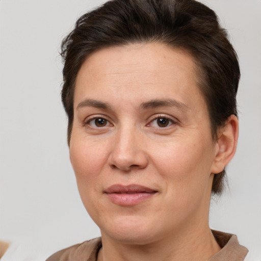 Joyful white adult female with short  brown hair and brown eyes