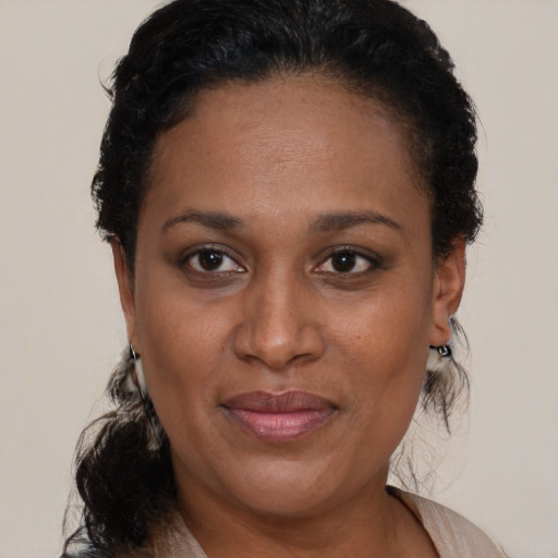 Joyful black adult female with short  brown hair and brown eyes