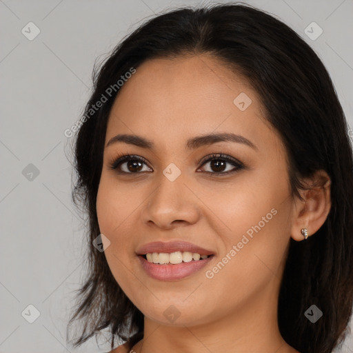 Joyful latino young-adult female with medium  brown hair and brown eyes