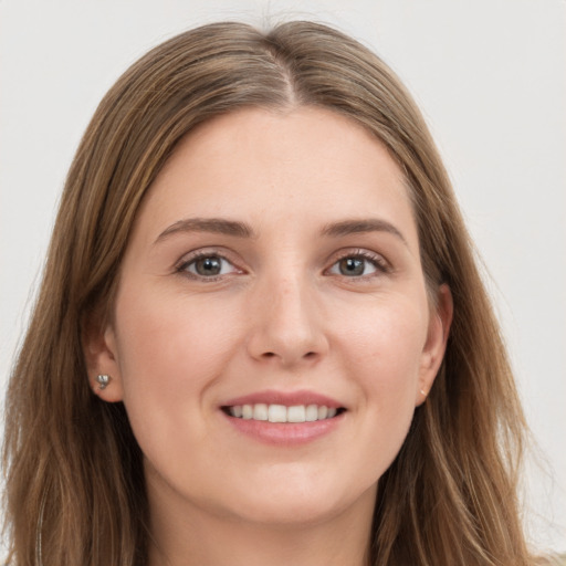 Joyful white young-adult female with long  brown hair and grey eyes