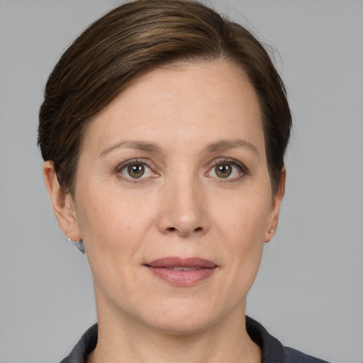 Joyful white adult female with short  brown hair and grey eyes