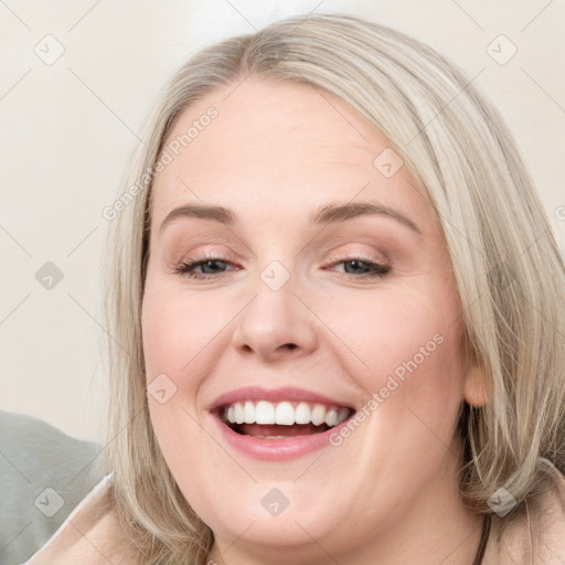 Joyful white young-adult female with long  brown hair and blue eyes