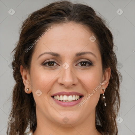 Joyful white adult female with long  brown hair and brown eyes