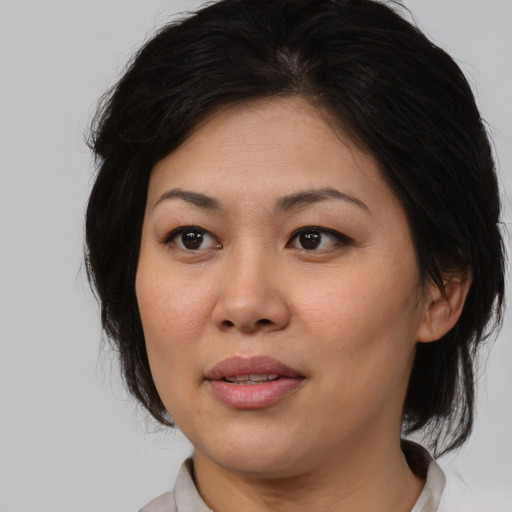 Joyful asian young-adult female with medium  brown hair and brown eyes