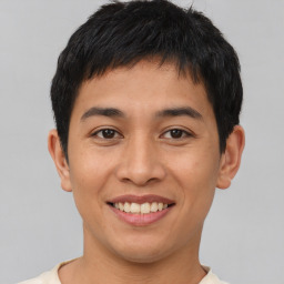 Joyful asian young-adult male with short  brown hair and brown eyes