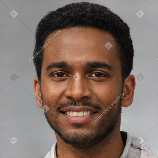 Joyful black young-adult male with short  black hair and brown eyes